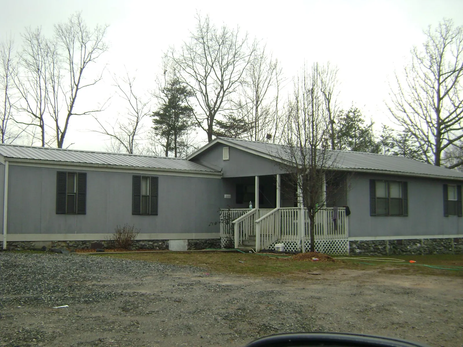Metal roof over a manufactured home with a covered front porch in Townsend